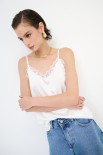 TOP CON PIZZO IN TINTA PANNA